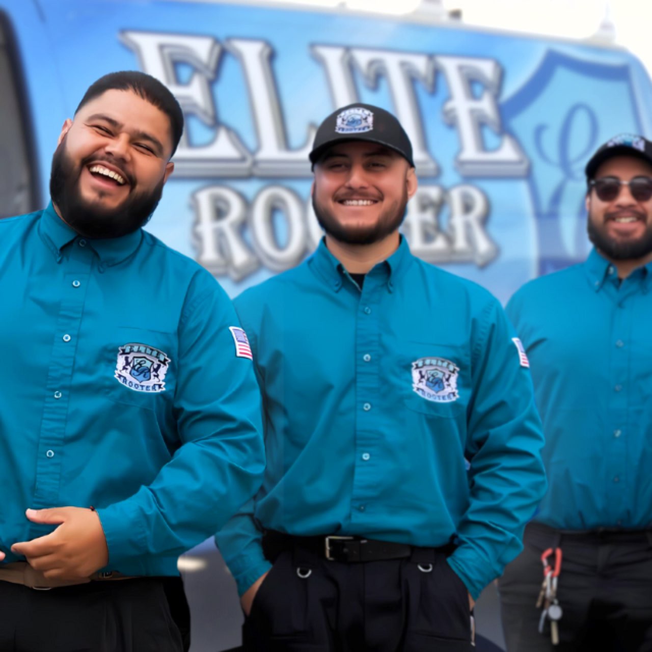 Three Elite Rooter technicians beside a branded service van