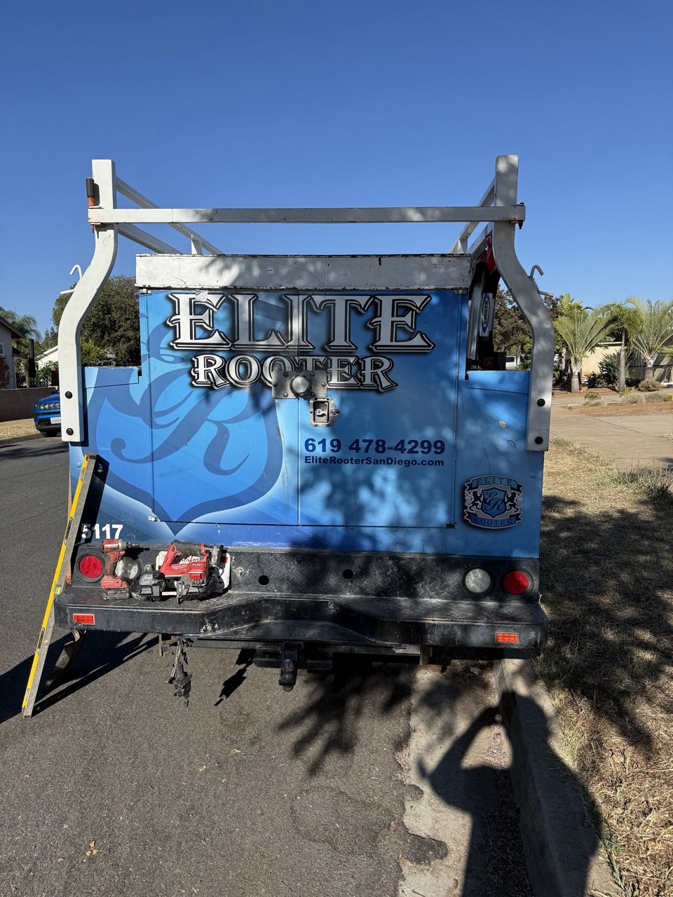 Rear of an Elite Rooter service truck carrying plumbing tools