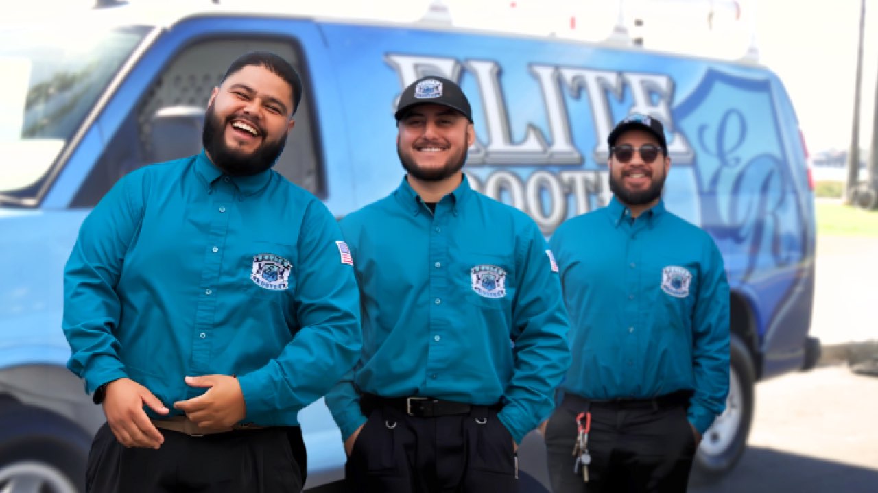 Three Elite Rooter technicians beside a branded service van